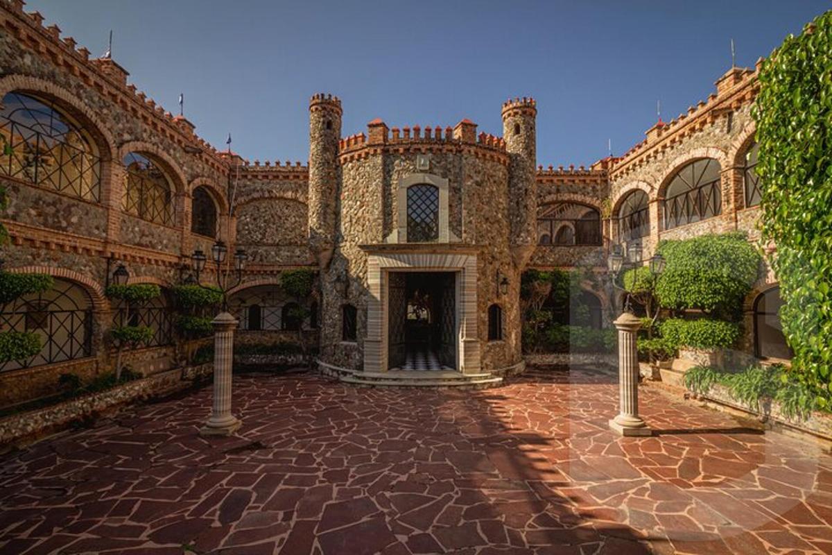 a large building with a brick courtyard with a doorway