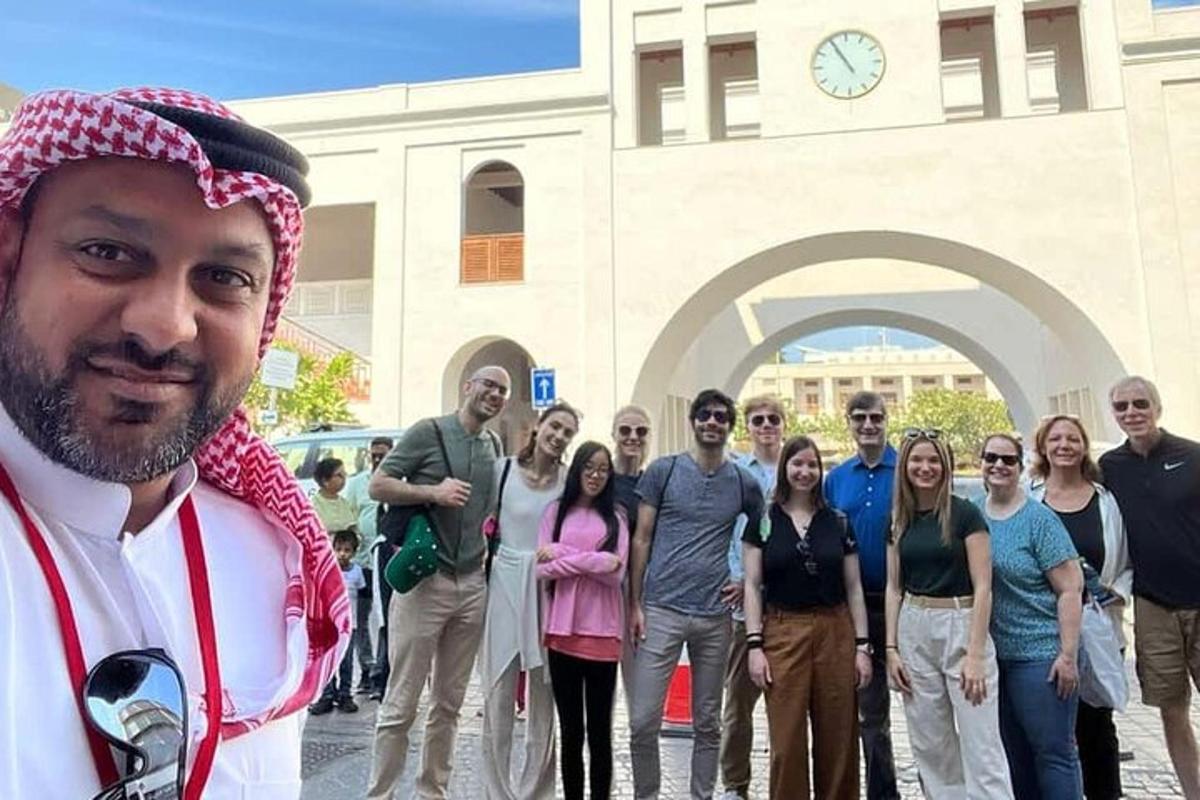 a group of people standing in front of a clock tower