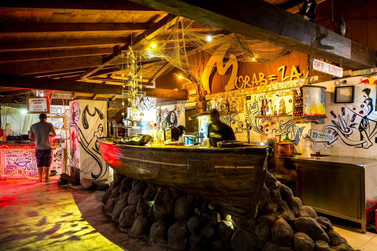 a bar with a wooden boat in a room with graffiti