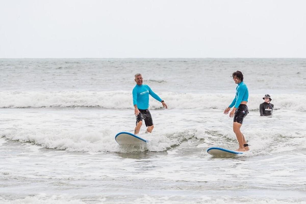 two people are standing on surfboards in the ocean