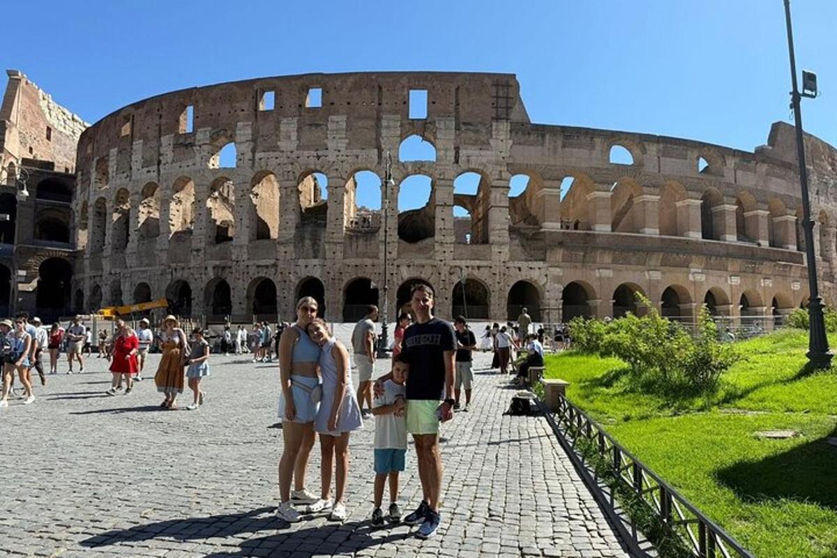 a group of people standing in front of the coliseum