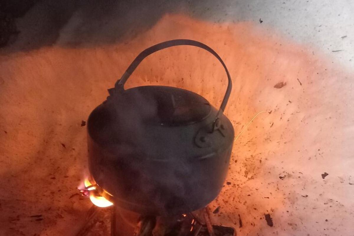 a large pot on top of a fire