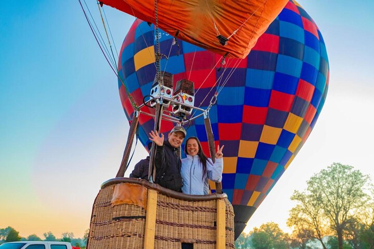 two people are riding a hot air balloon