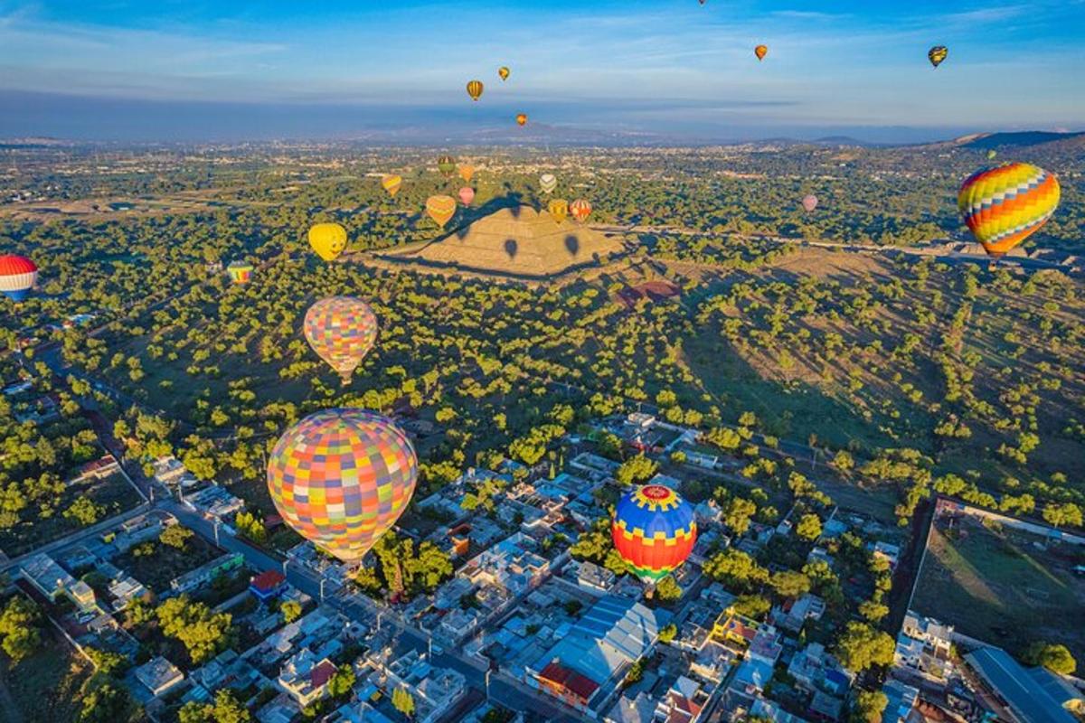 a group of hot air balloons flying over a city