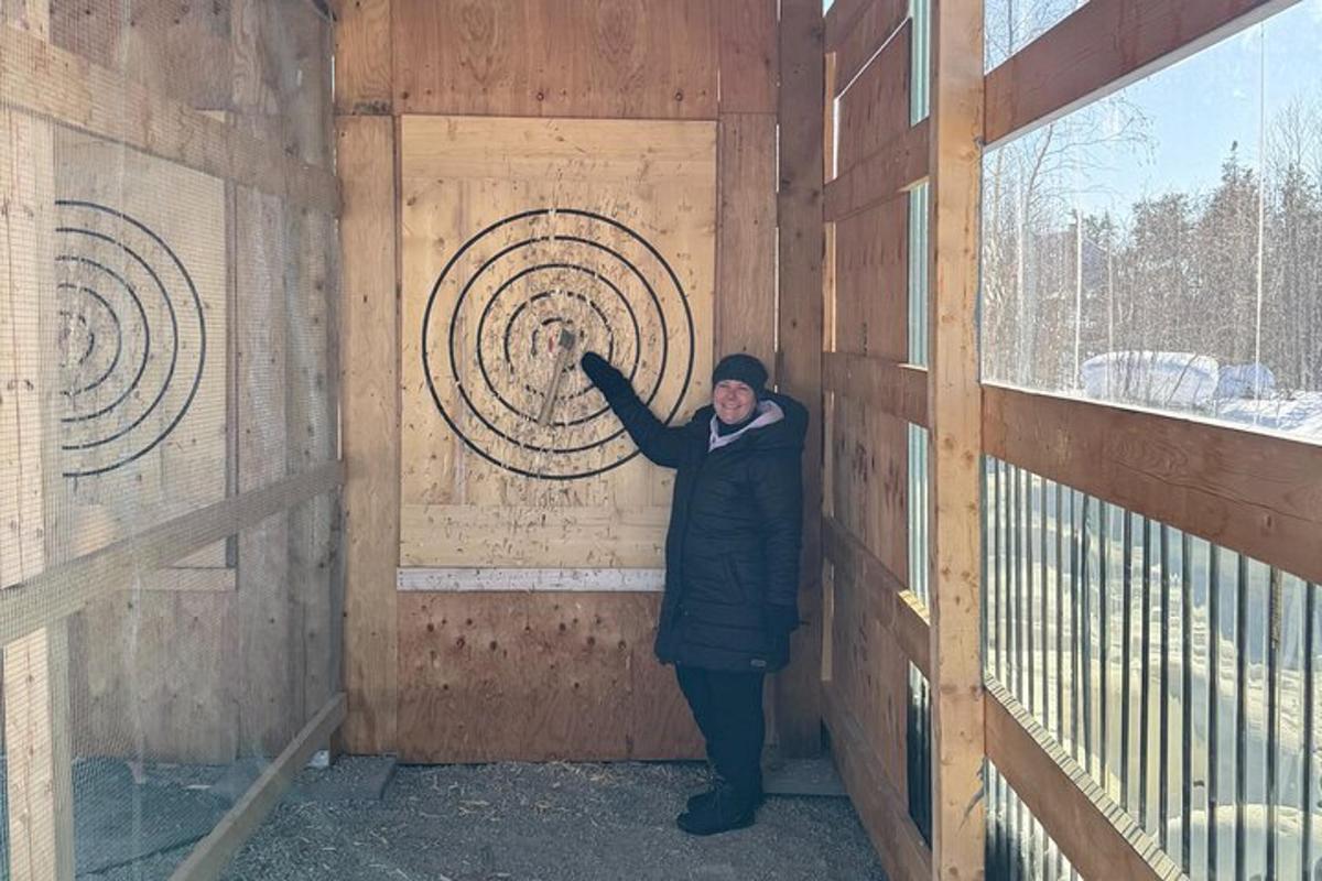 a person standing in a wooden door with a fan
