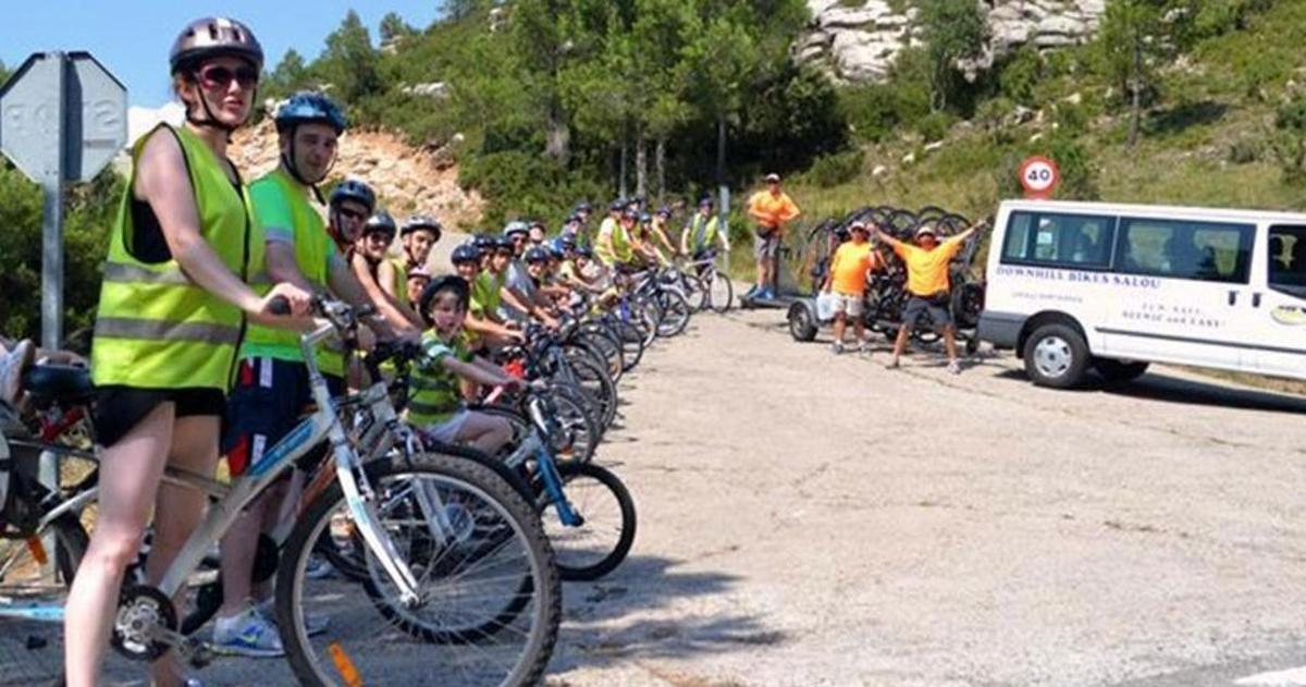 a large group of people riding bikes down a road
