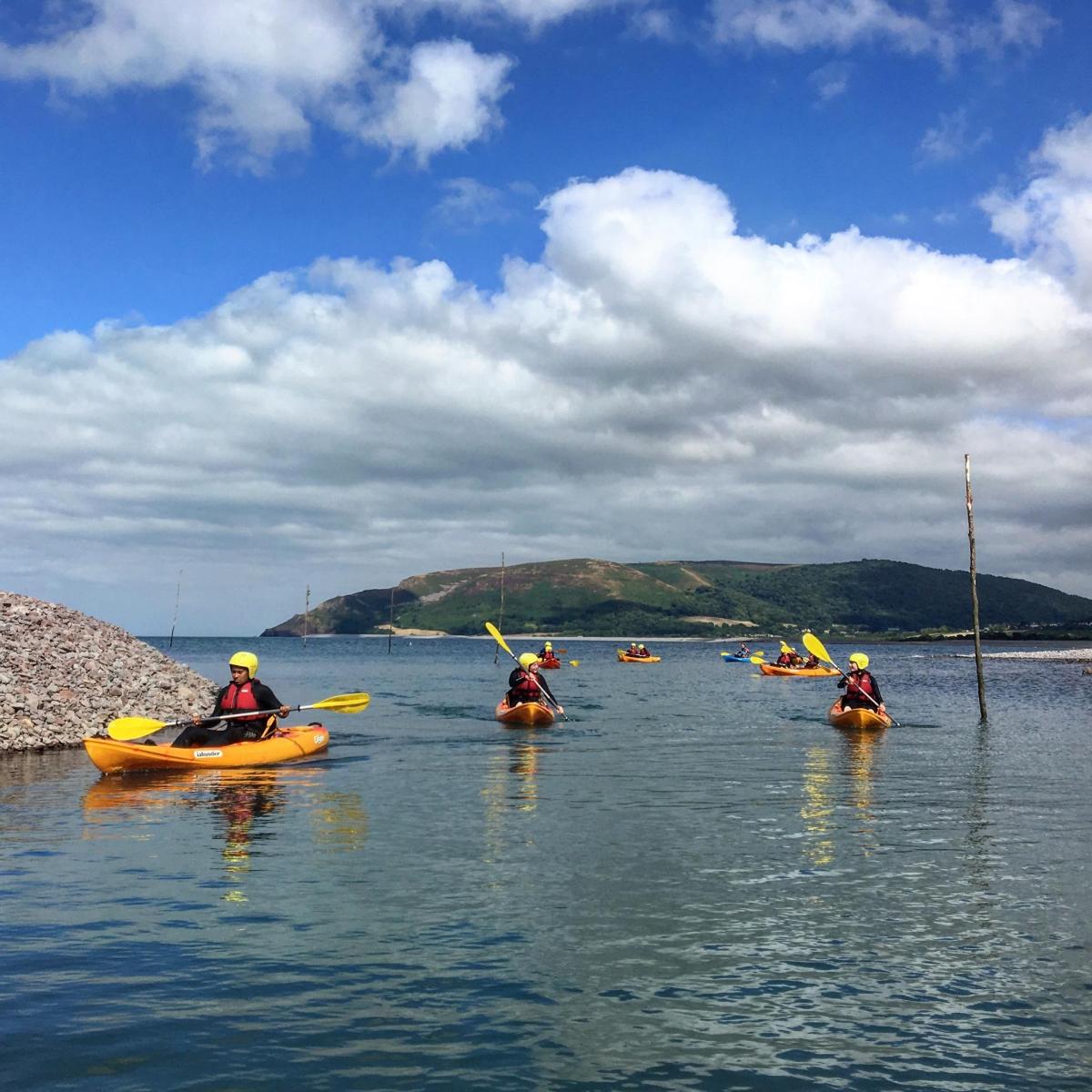 a group of people kayaking on a body of water