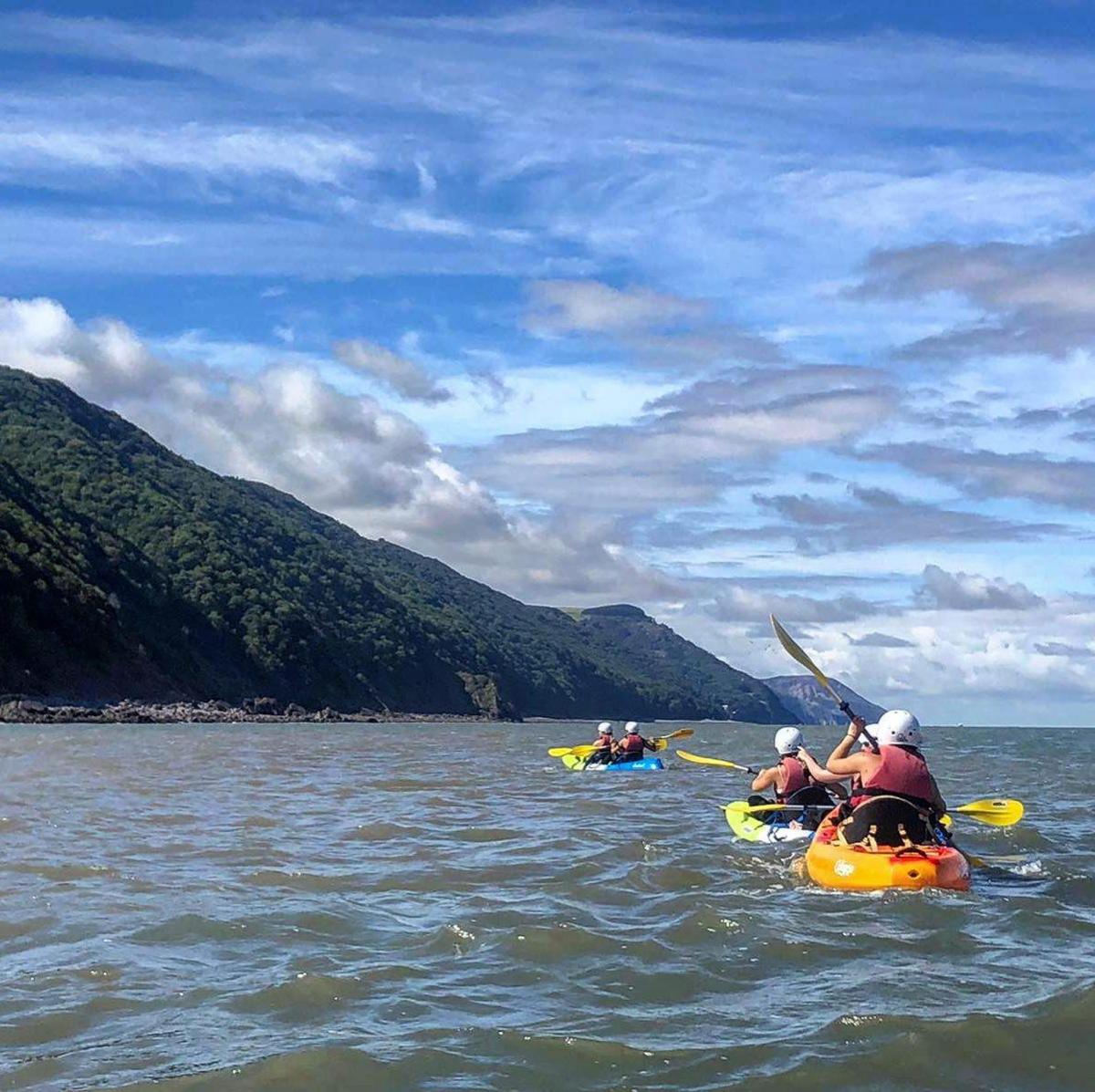 a group of people kayaking on a body of water