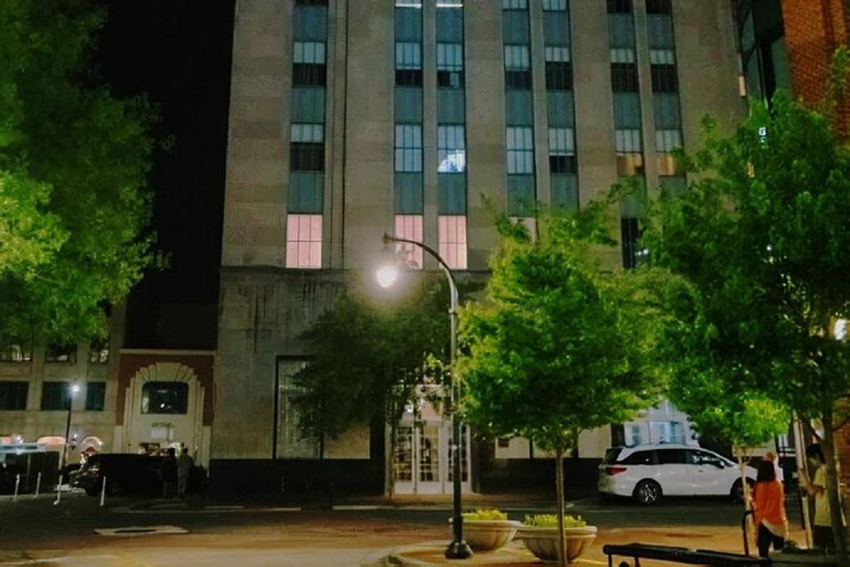 a street light in front of a building at night