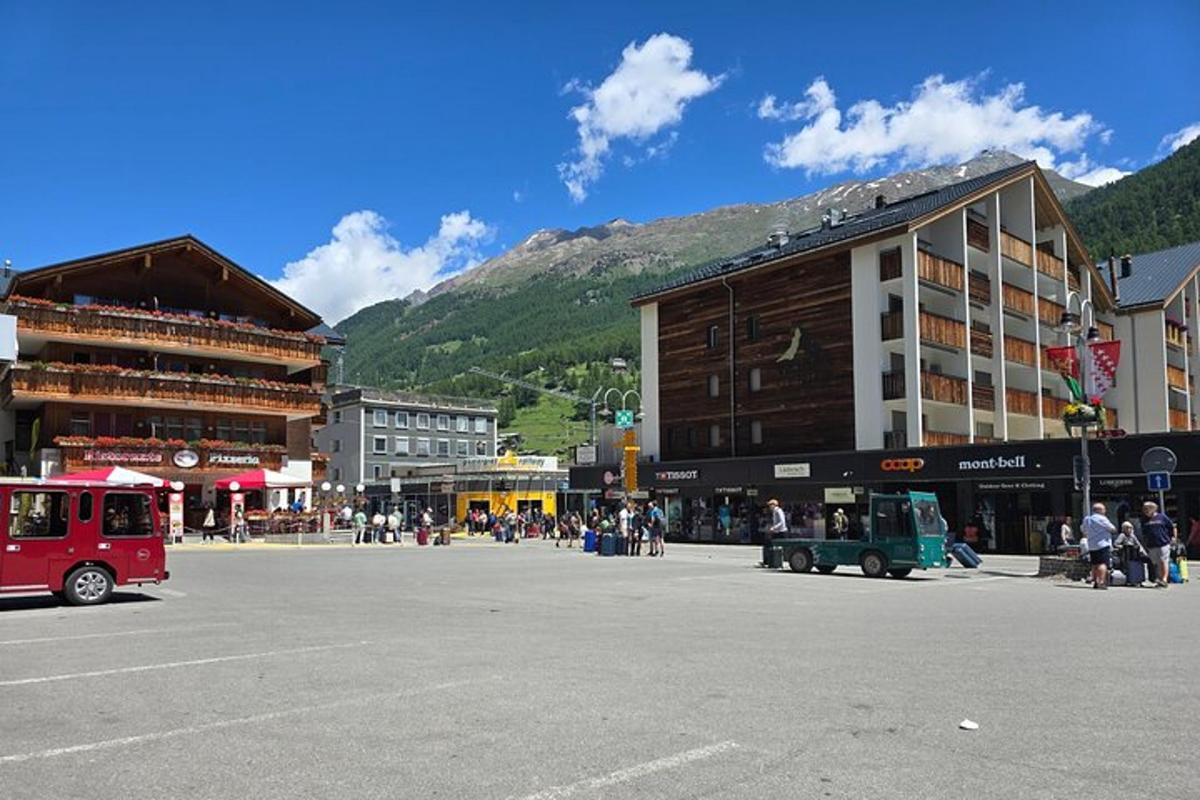 a street in a town with buildings and a mountain