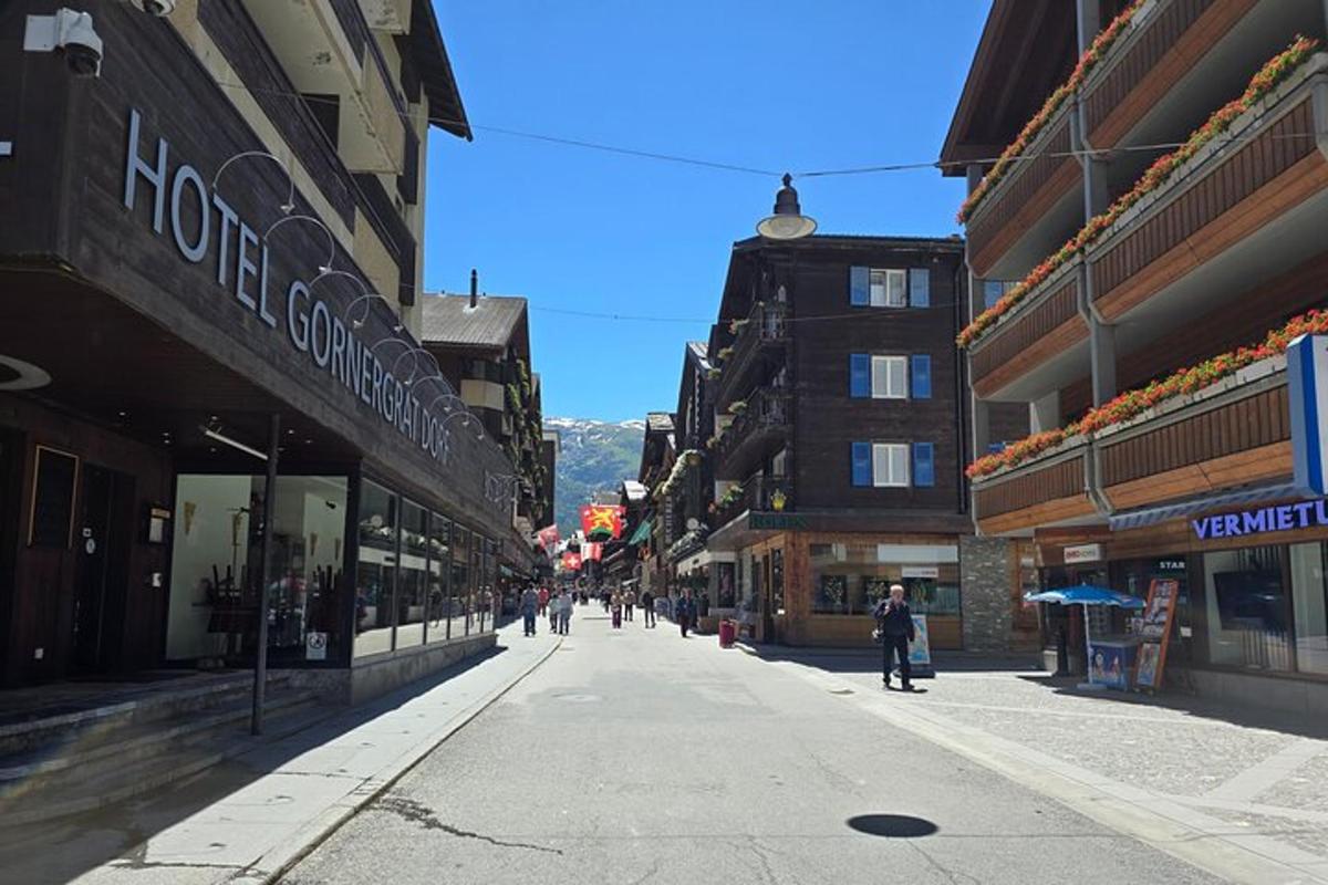 an empty city street with people walking down the street