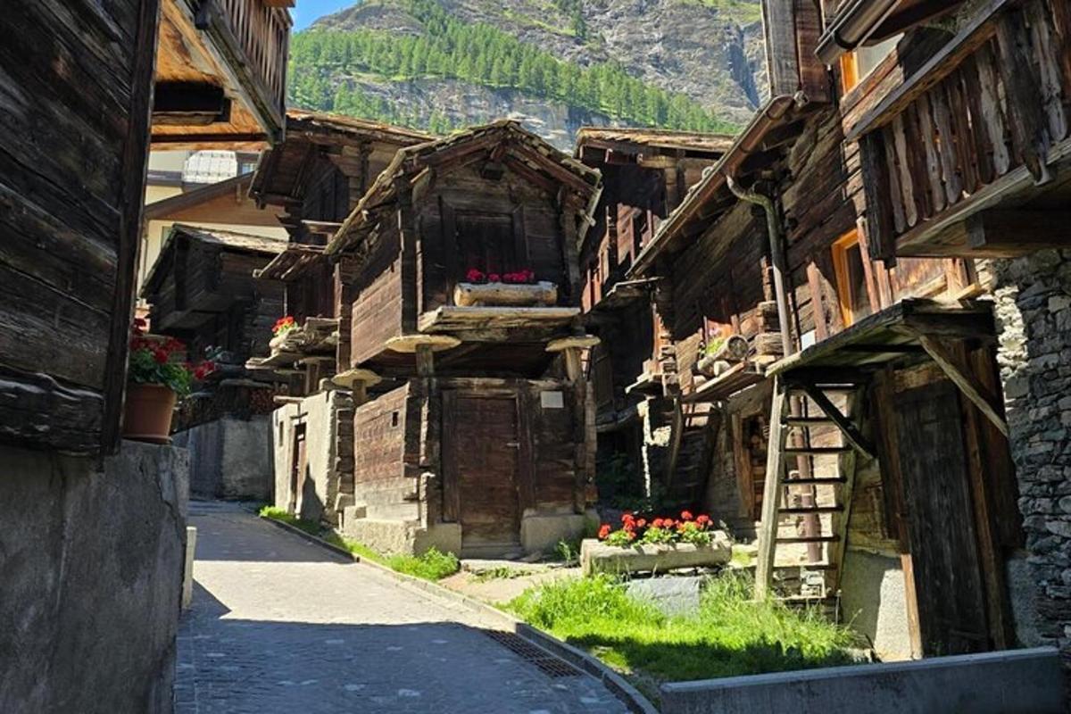 an alley of an old building with flowers in a village