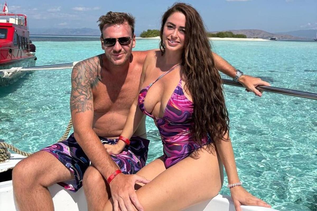 a man and a woman sitting on a boat in the water