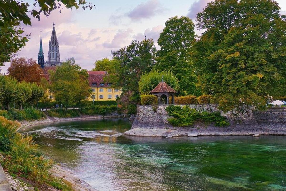 a river with a bridge and a church in the background