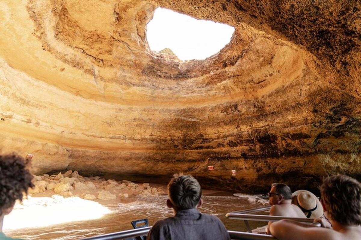 a group of people in a boat in a cave