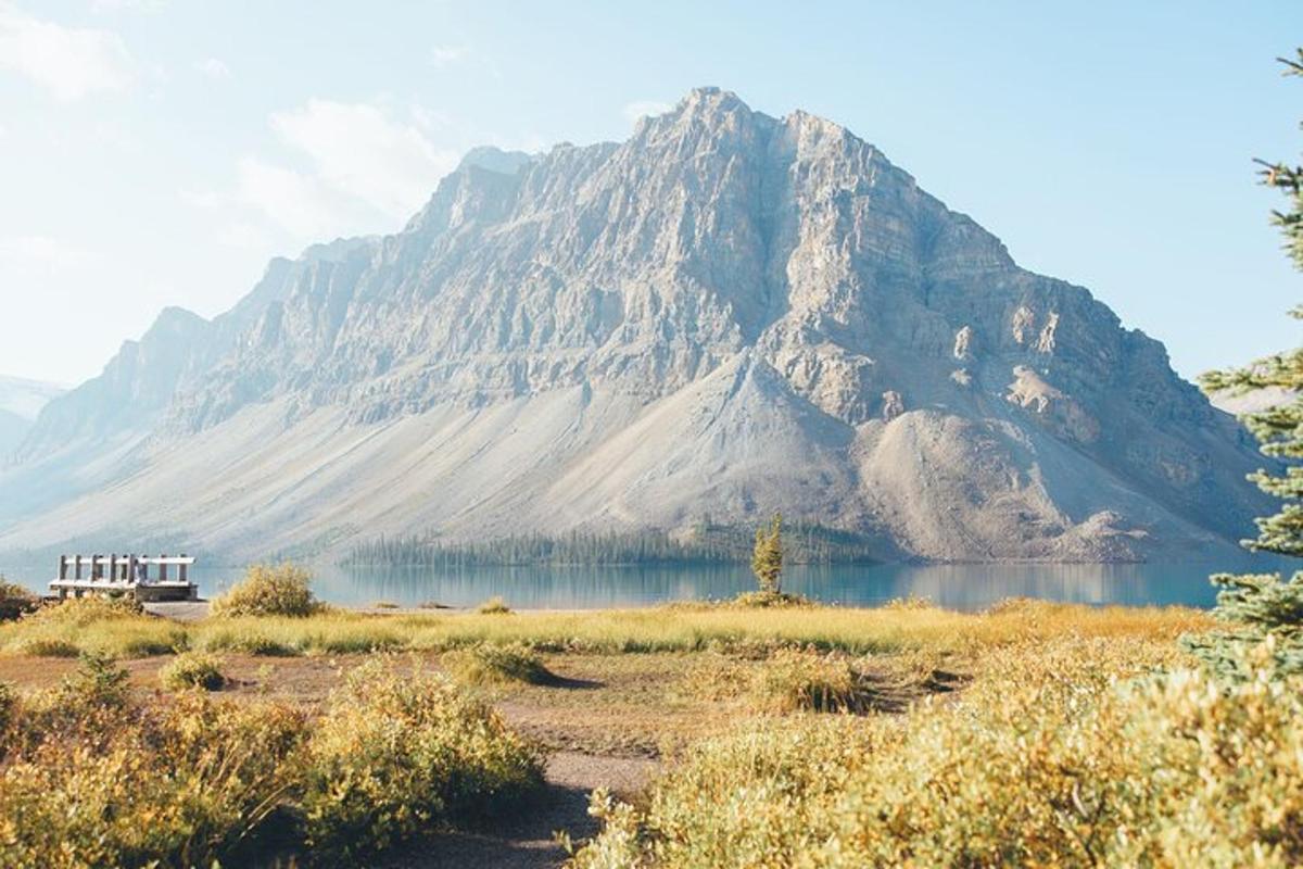 a large mountain sitting next to a body of water