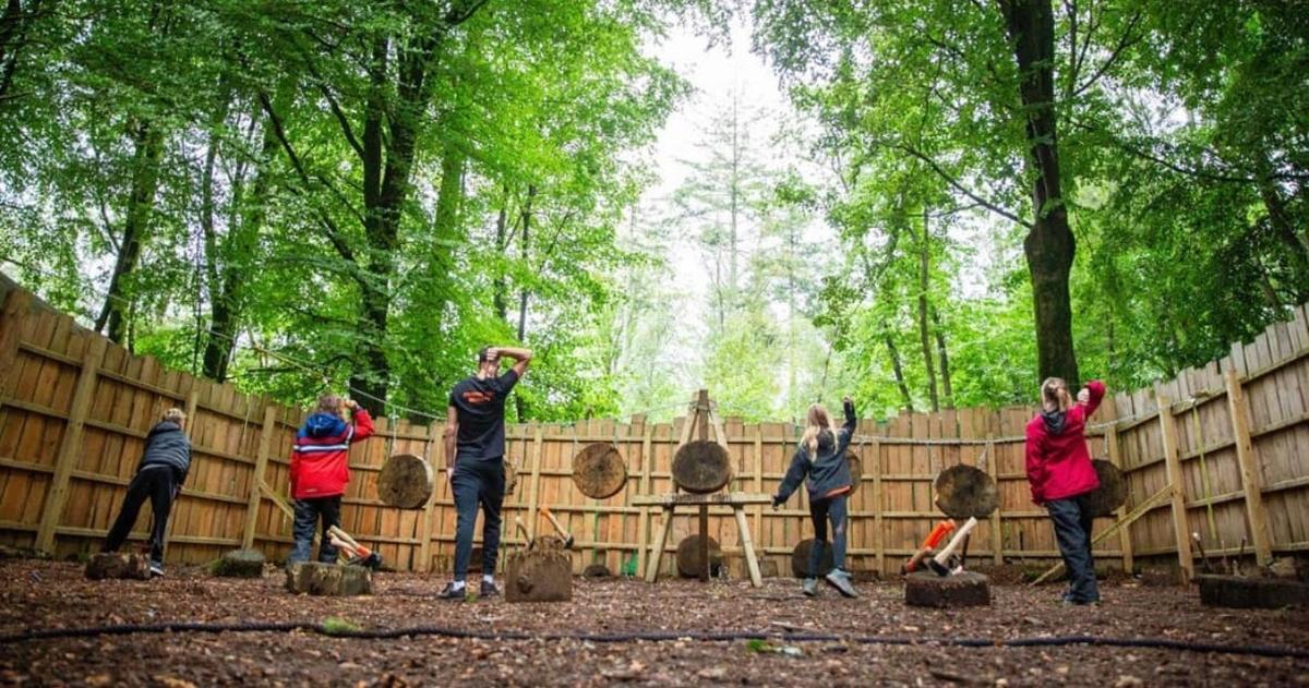 a group of people standing in front of a fence