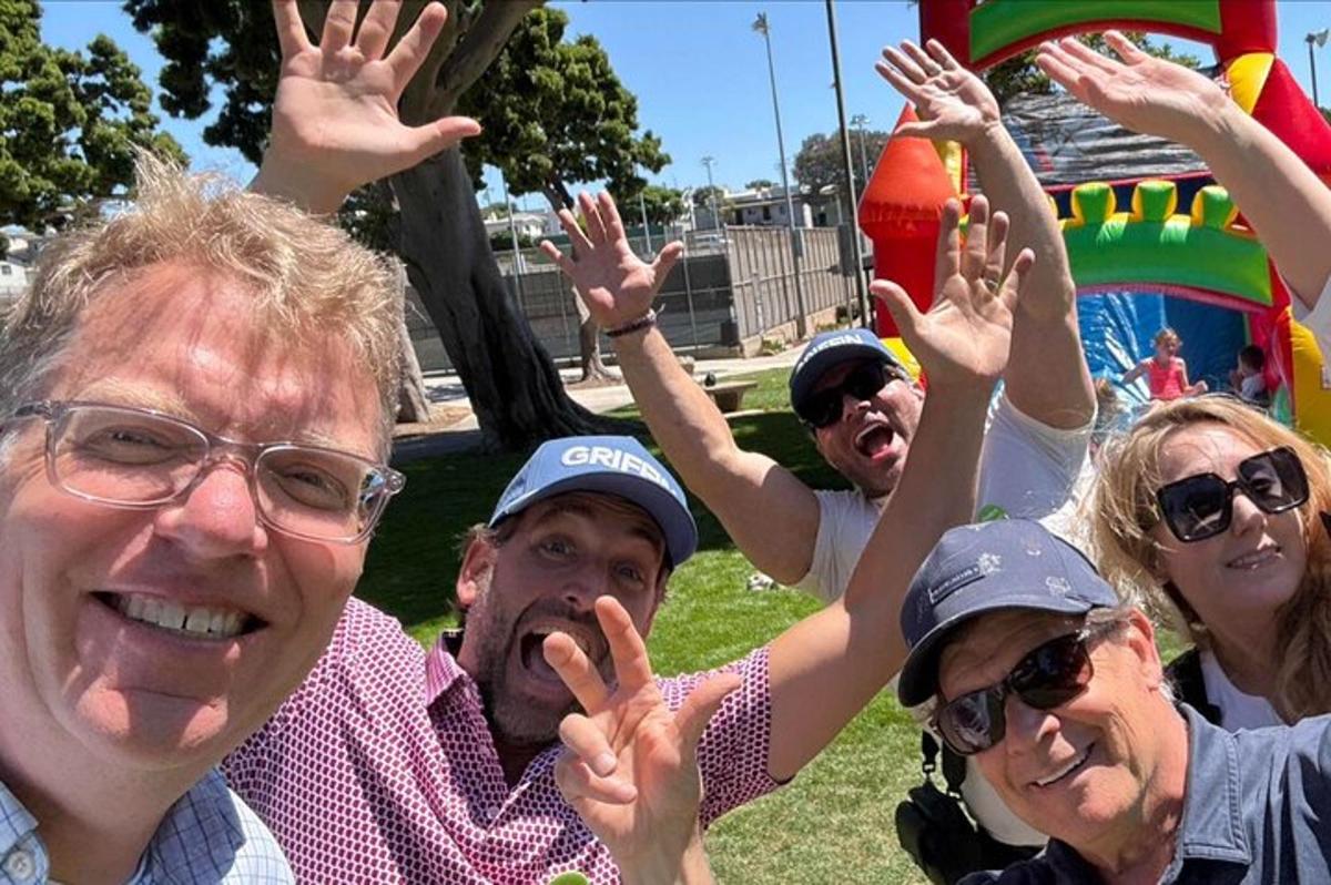 a group of people with their hands in the air