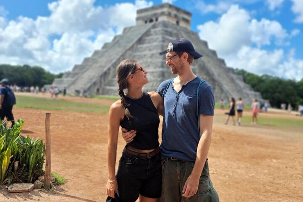 a man and a woman standing in front of a pyramid