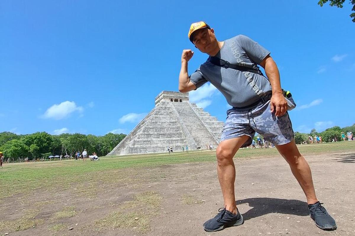 a man standing in front of the pyramid