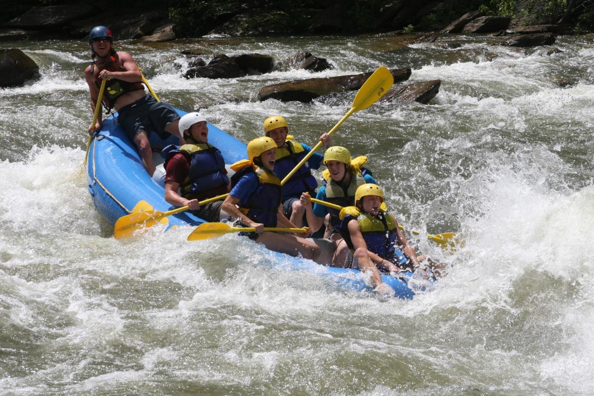 a group of people in a raft on a river