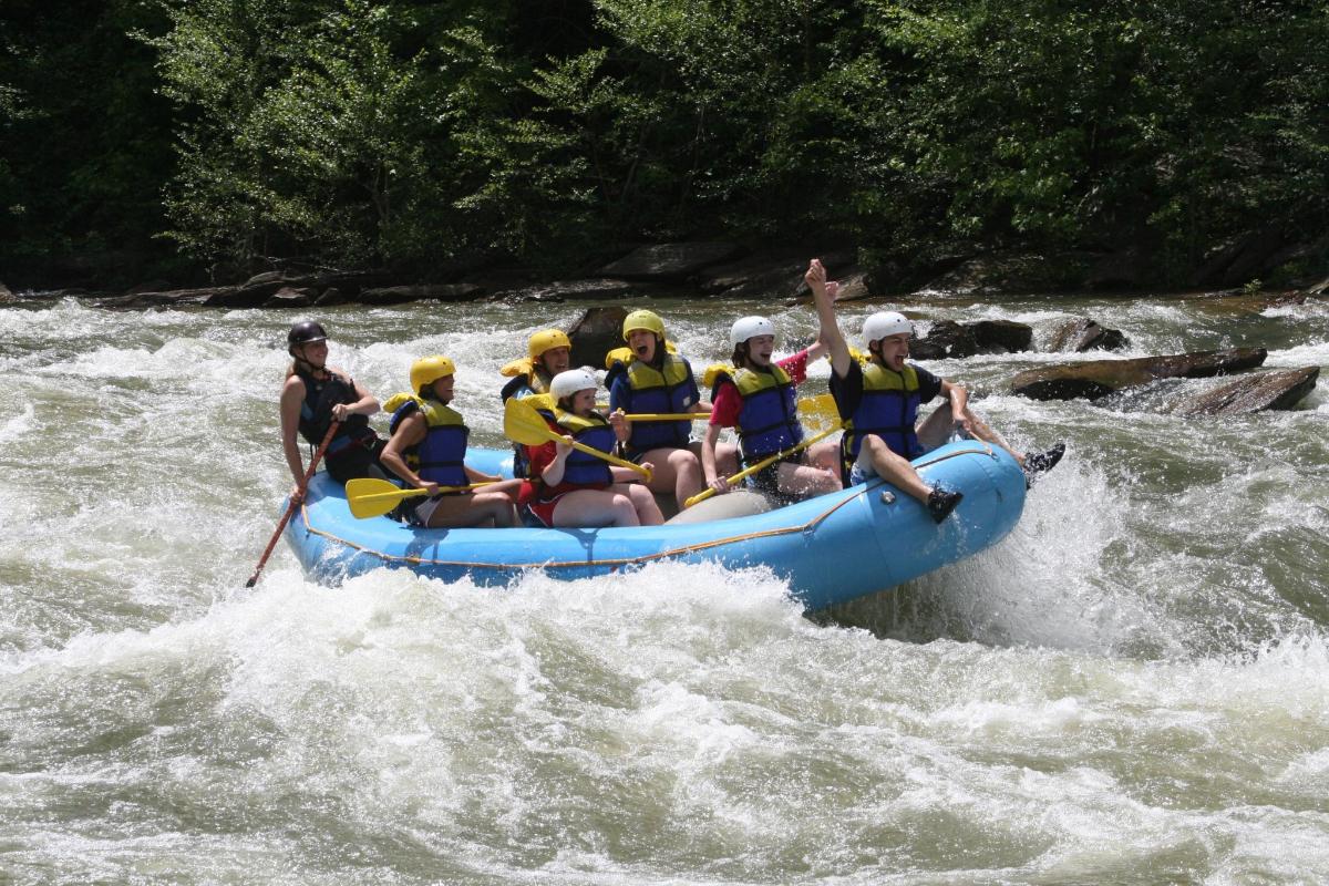 a group of people in a raft on a river