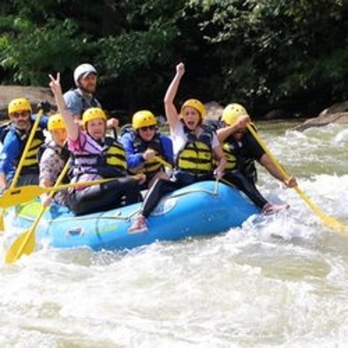 a group of people in a raft on a river
