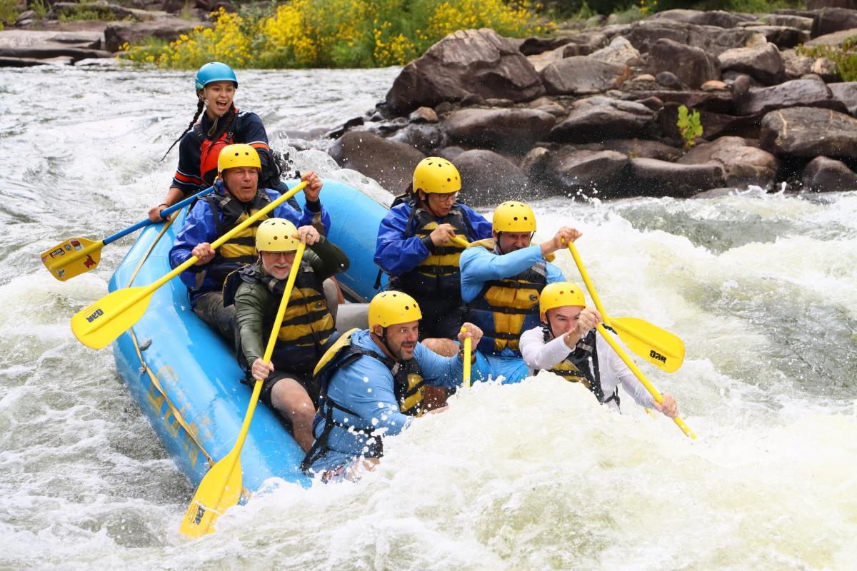 a group of people in a raft on a river