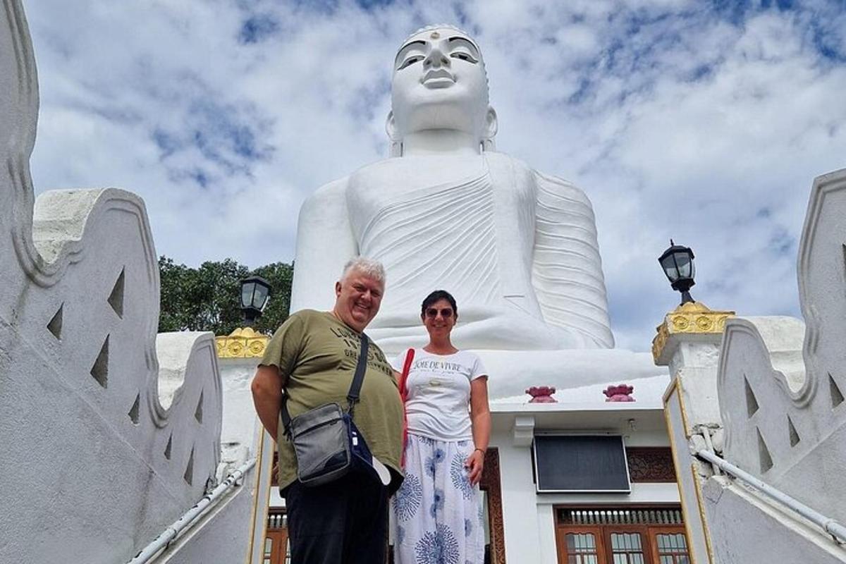a man and a woman standing in front of a statue