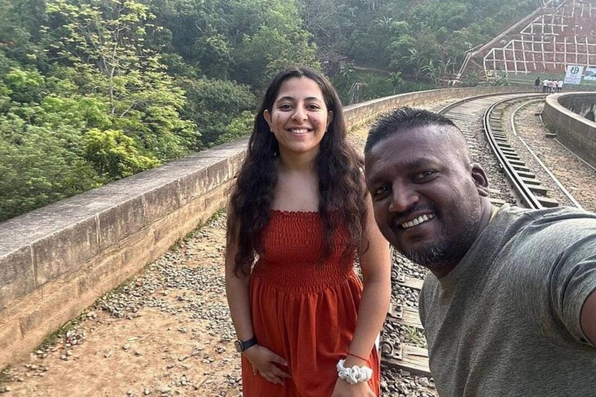 a man and a woman standing on a train track