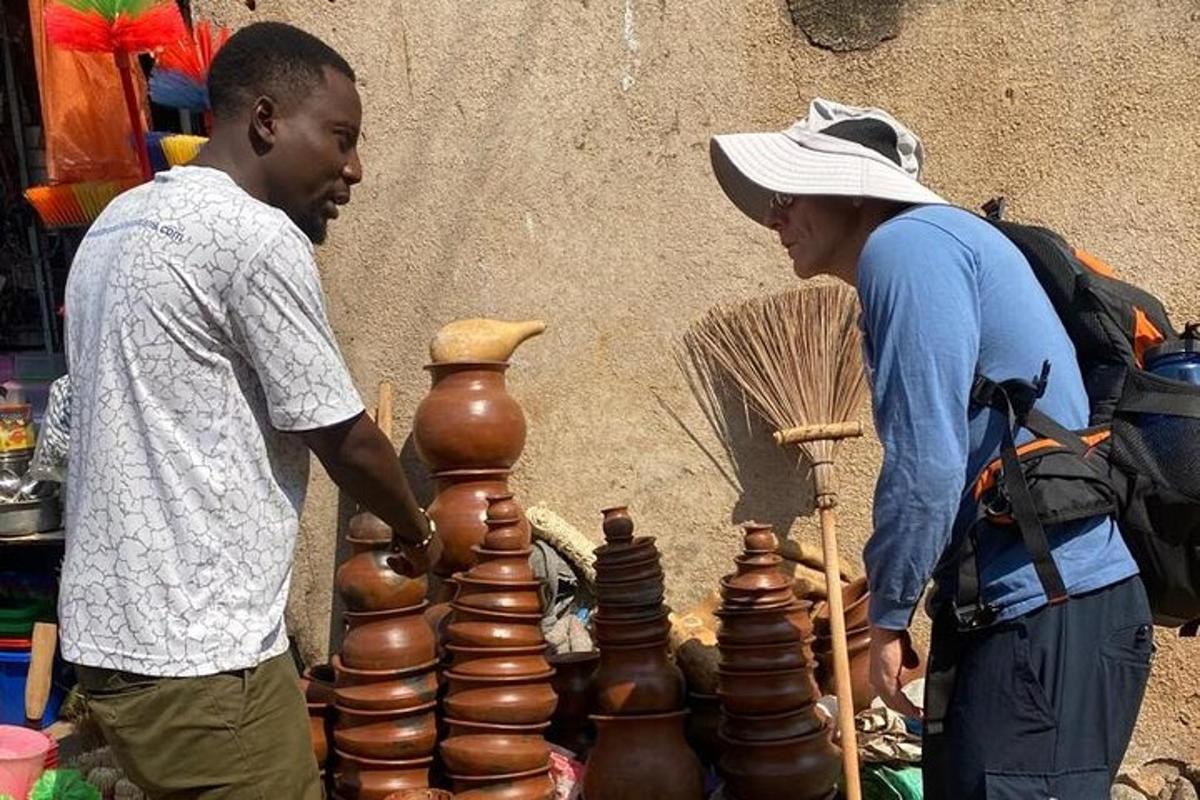 a man and a woman standing next to a stack of vases