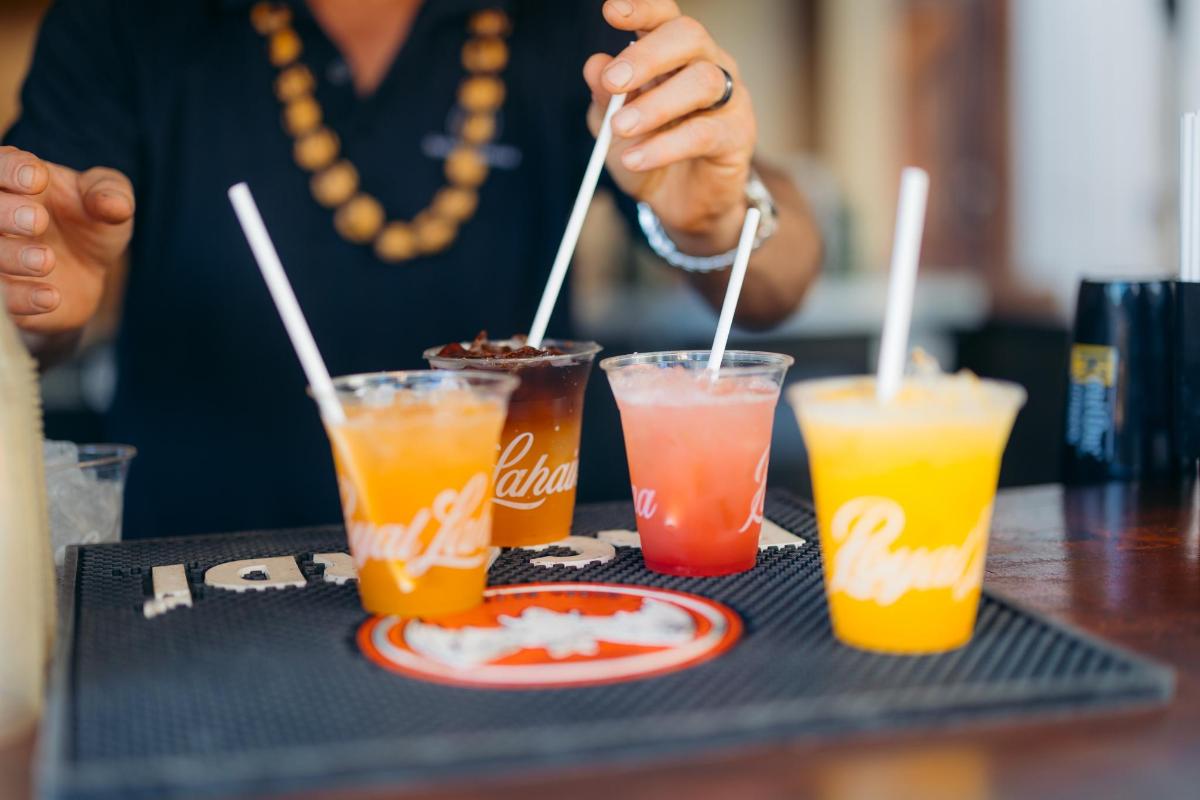 a person sitting at a table with three drinks