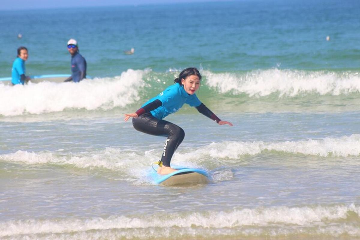 a young girl riding a wave on a surfboard in the ocean