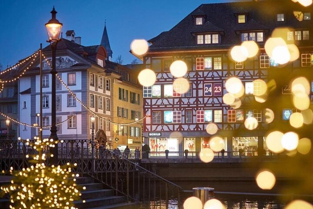 a lit up christmas tree in front of buildings