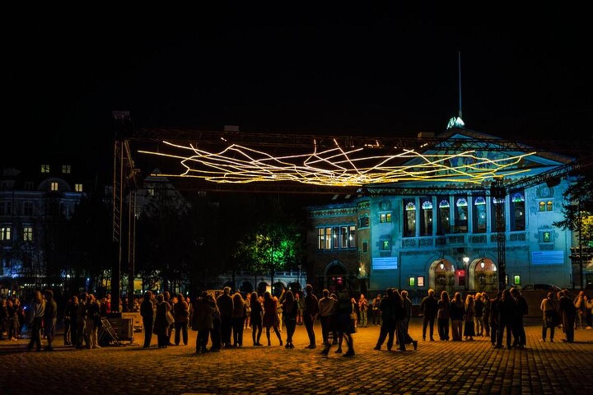 a group of people standing in front of a blue building