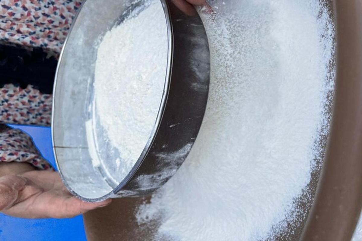 a person holding a pot filled with white flour
