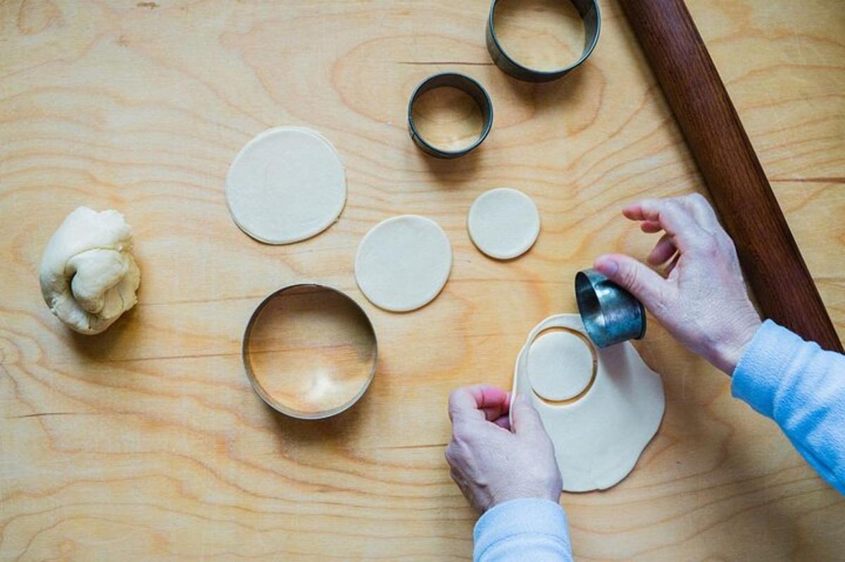 a person is holding a cup on a wooden table