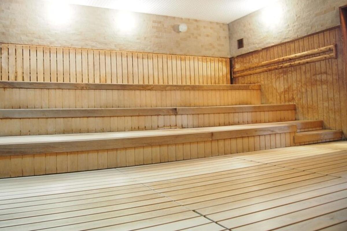 an empty gym with wooden benches in a room