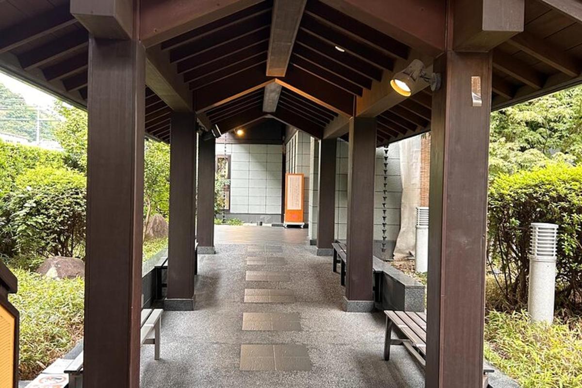 a covered walkway with benches under a building