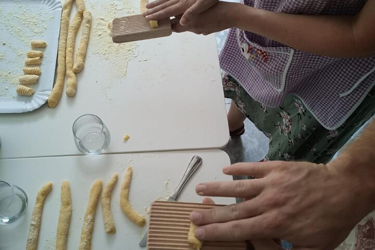 a person cooking food on a counter with a cutting board