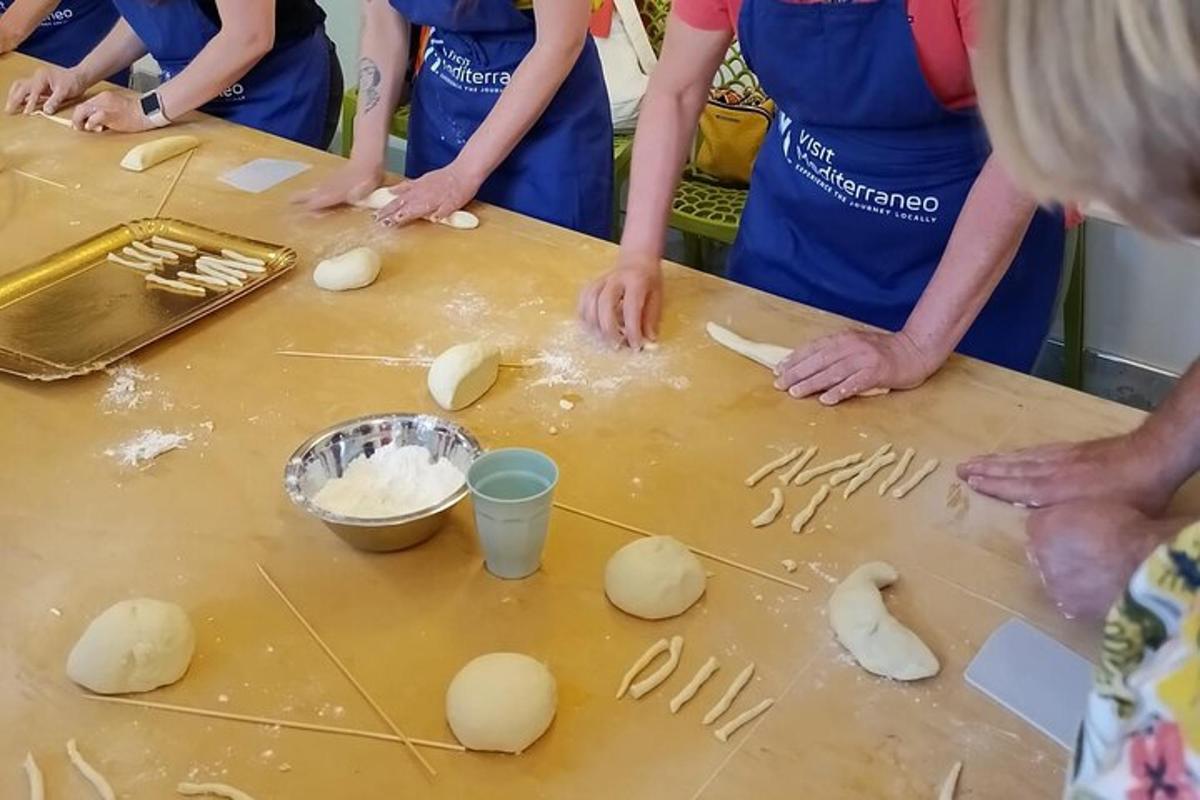 a group of people standing around a table with dough