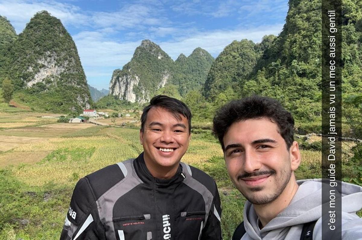 two men posing for a picture in front of a mountain