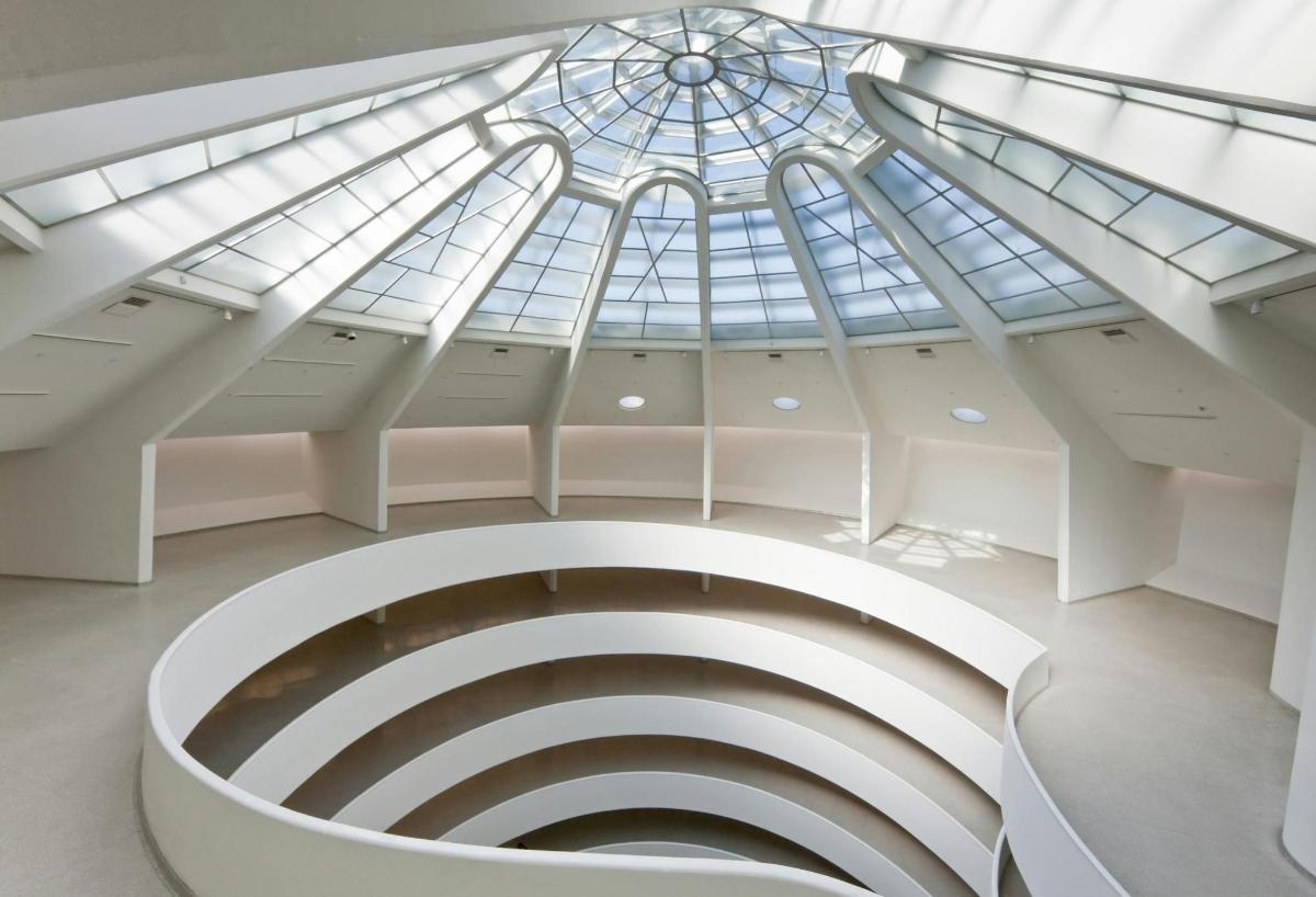a spiral staircase in a building with a glass ceiling
