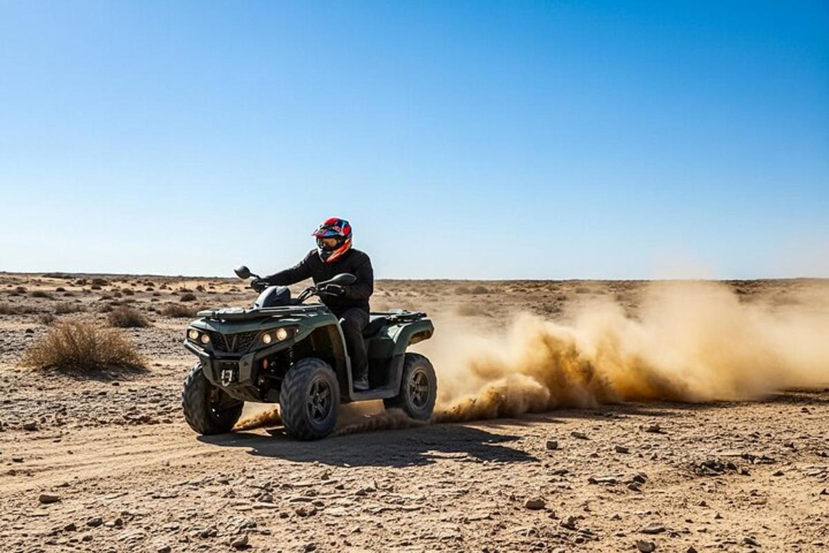 a man riding a quad bike in the desert
