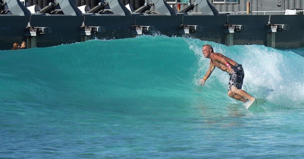 a man riding a wave on a surfboard in the water