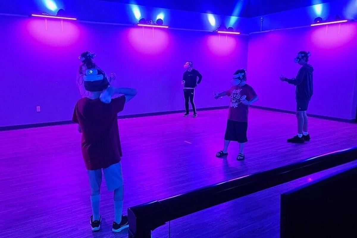a group of people dancing in a purple room