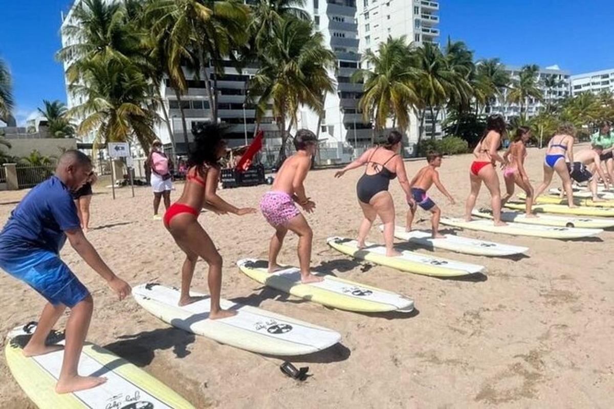 a group of people standing on surfboards on the beach