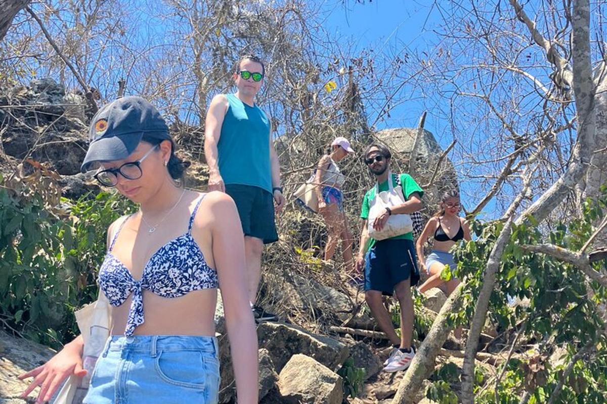 a group of people walking up a rocky trail