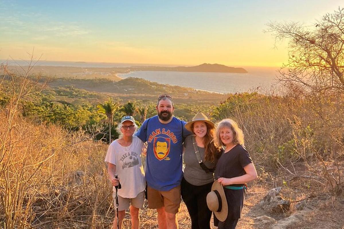 a group of people standing on top of a hill