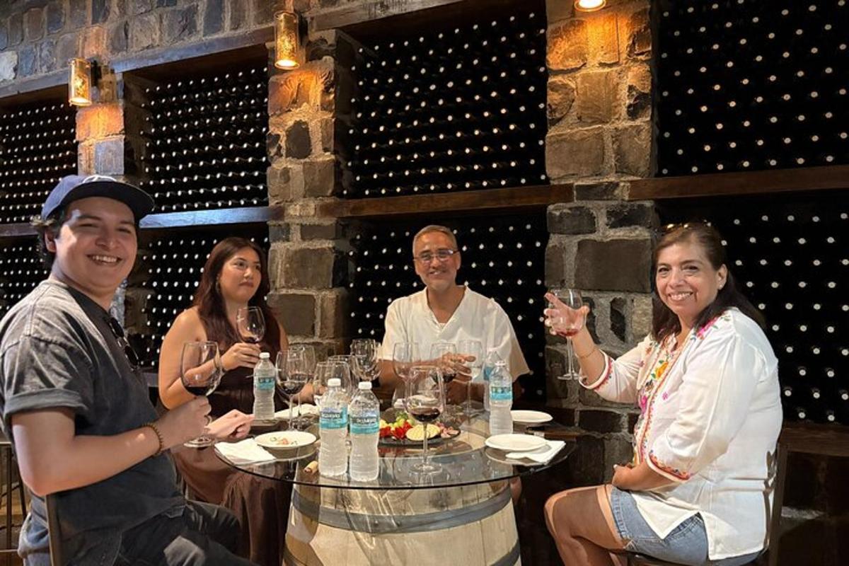 a group of people sitting at a table with wine glasses